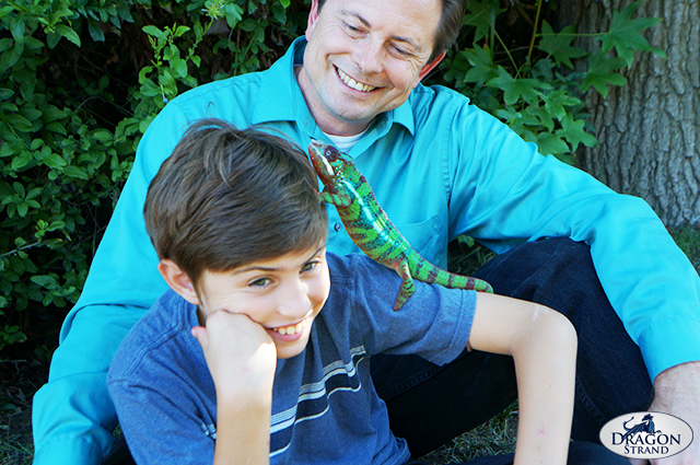 A dad, a boy, and his chameleon